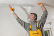© sima - Worker repairing plaster at ceiling