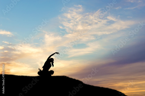 Obraz na plátně Silhouette of woman doing yoga at sunset