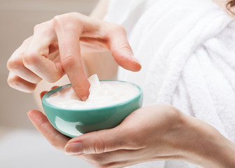 Woman holding bowl with nourishing mask