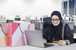 © Creativa Images - Happy Arabian businesswoman shopping online