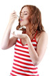 © azhurfoto - Young female enjoying taste of yogurt isolated on white