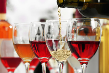 White wine pouring into glasses, closeup