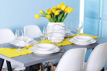 Wall Mural - Table served with dishes and a bouquet of tulips