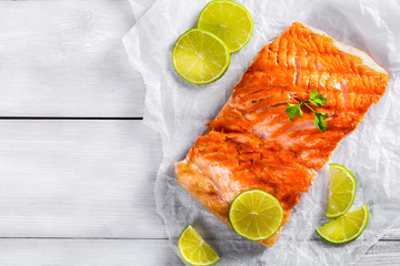 Sticker - salmon fillet on a white parchment paper, top view