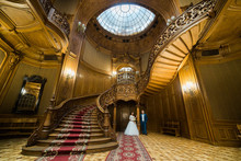 Elegant Wedding Couple Standing At Old Vintage House And Palace With Big Wooden Stairs