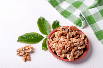 Wall Mural - walnut kernels in a bowl on a table