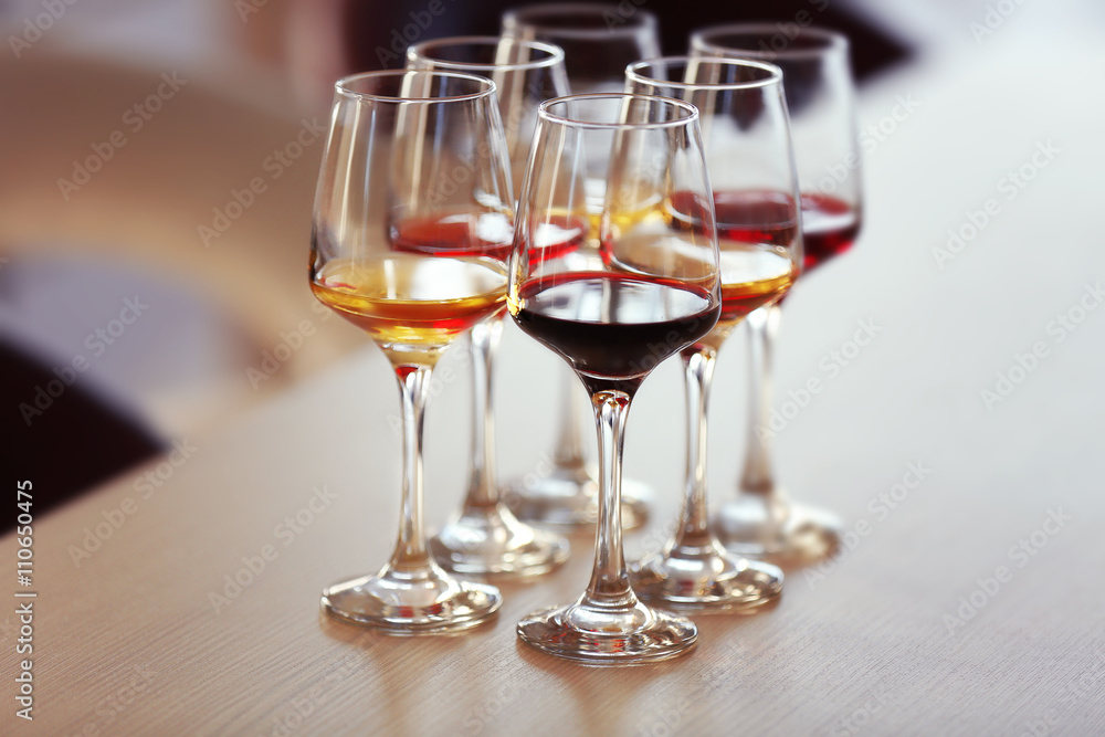 Many glasses of different wine on a table