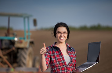 Wall Mural - Woman showing thumb up in field