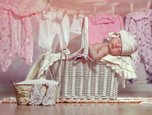 Newborn Baby Asleep In The Basket After Helping Her Mother In The Laundry Washing