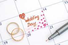 Reminder Wedding Day In Calendar With Pen And Two Wedding Rings