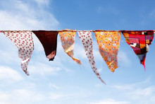 Colorful Homemade Bunting Triangular Flags Hanging, Blue Sky With Clouds