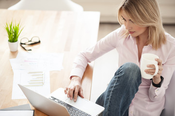 Sticker - Attractive young woman is using a notebook