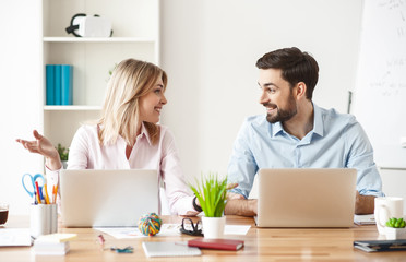 Wall Mural - Skillful two workers are talking in office