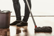 Closeup of human cleaning mopping floor.