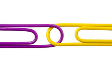 Cropped Image Of Two Paper Clips On White Surface.