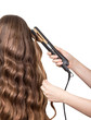 © laboko - Hairdresser makes curly long brown hair isolated on white.