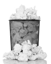 Metal Trash Can Overflowing With Paper Waste Isolated On White.