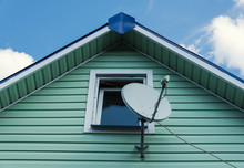 Satellite Dish On A Wall Of Wooden Village House