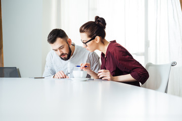 Two concentrated businesspeople working together in office