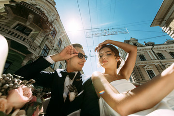 Wall Mural - Buildings and amazing couple in the car