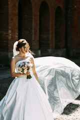 Wall Mural - Nice portrait of the amazing bride with the bouquet