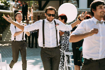 Wall Mural - Funny groomsmen on the wedding ceremony