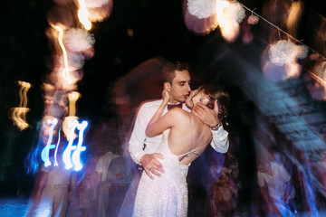 Wall Mural - Colorful light and a kiss on the dance floor