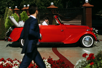 Wall Mural - Friend waits for a groom in the red car