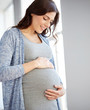 © Syda Productions - happy pregnant woman with big tummy at home