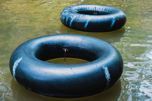 Old Inner Tubes Floating On A River, Selective Focus