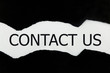 © FATIR29 - contact us word written under black torn paper