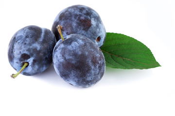 Canvas Print - Organic plums fruit with leaf on white. Closeup.