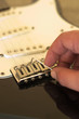 Hand close-up. Tuning a vintage guitar. 