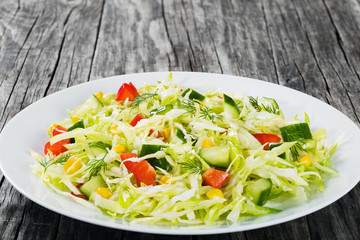 Poster - spring cabbage salad with bell pepper, corn and dill, close-up