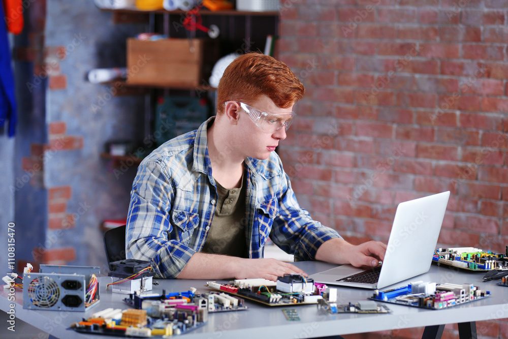 Young man working in repair center