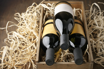 Poster - Wine bottles in wooden box and straw