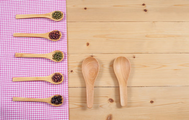 Tablecloth, wooden spoon, on wood textured background