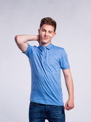 Wall Mural - Boy in jeans and t-shirt, young man, studio shot