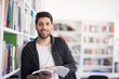 © .shock - portrait of student while reading book  in school library