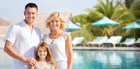 Wall Mural - happy family over hotel resort swimming pool