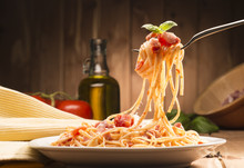 Spaghetti With Amatriciana Sauce In The Dish On The Wooden Table