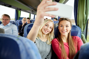 Sticker - women taking selfie by smartphone in travel bus