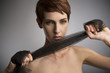 © Connect Images - Studio portrait of woman pulling black silk scarf around hands