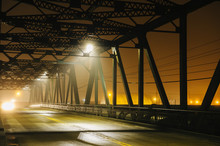 Road And Silhouetted Iron Bridge At Night, Tacoma, Washington, USA