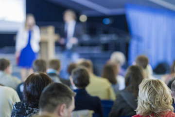 Groups of People Concept and Ideas. Two Hosts Speaking In front of the Group from Stage