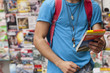 © Connect Images - Cropped shot of young male tourist reading map, Copacabana town, Rio De Janeiro, Brazil