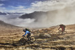 © Connect Images - Two men mountain biking in landscape