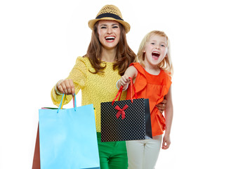 Wall Mural - Portrait of happy mother and daughter showing shopping bags