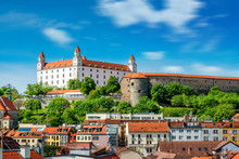 View on Bratislava castle on the green hill with old houses at the bottom from the Michael's watch tower in Slovakia