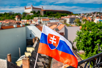 Canvas Print - Slovak flag on the old town background and Bratislava castle in Slovakia